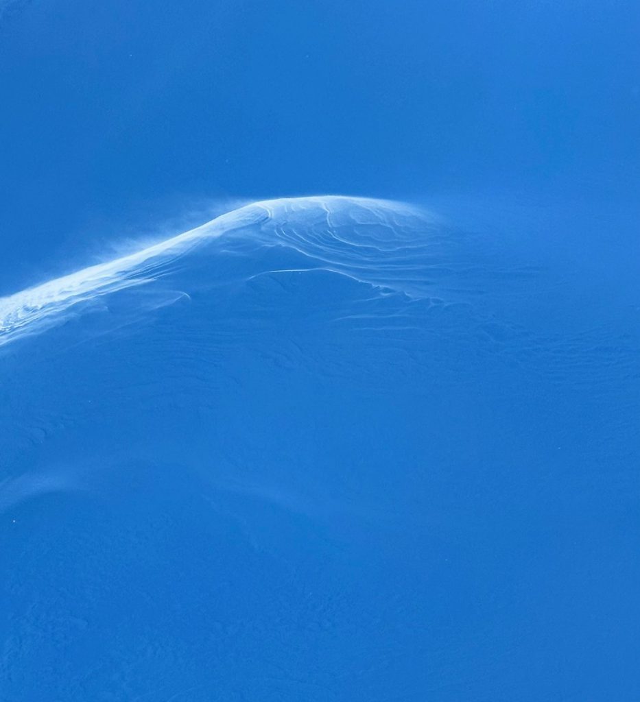 a person riding skis down a snow covered slope
